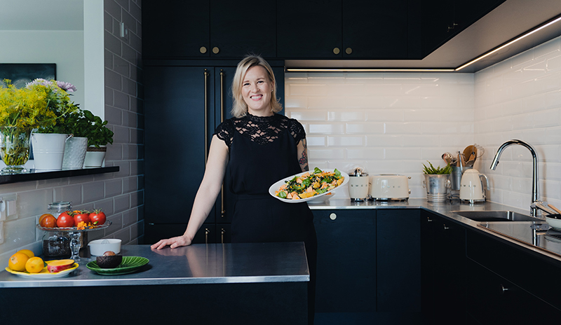 A beautiful black kitchen with steel worktops